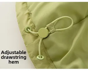 Close-up of olive green down jacket hem with adjustable drawstring and toggle component