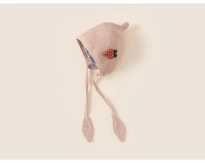 Detail of pink knitted baby earflap hat with strawberry embroidery and soft lining