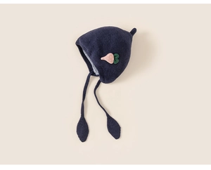 Detailed knit texture and strawberry embroidery on navy blue earflap baby hat