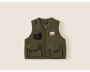Close-up of olive green kids outdoor vest showing quilted lining and embroidery