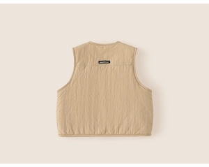 Back view of khaki quilted kid's vest showing fabric texture and woven brand label
