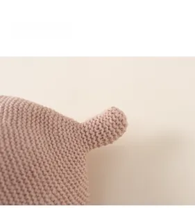 Detail of the soft pink knit texture and cute ear design on this girls' ear protection hat