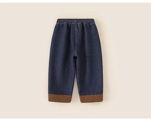 Detail view of boys fleece-lined denim pants with brown corduroy cuffs and elastic waist