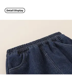 Detail view of boys fleece-lined denim trousers with elastic waistband and side pockets