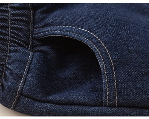 Detail view of boys fleece-lined denim jeans showing elastic waist and white stitching