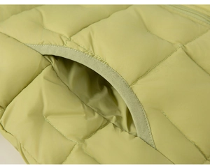 Macro shot of grid-quilted fabric and seamless pocket on kids' lightweight down jacket