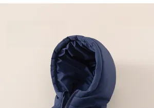 Detail view of navy blue hooded puffer jacket with a functional zip and windproof fabric