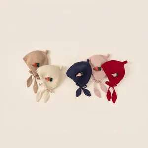 Girl's knit earmuff hat with cute strawberry patch and leaf-shaped tie straps