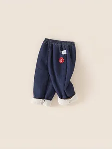 Boys warm deep blue denim trousers with white fleece lining and festive red embroidery