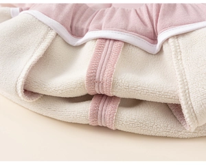 Detailed view of pink ribbed knit fabric with warm sherpa fleece lining and white piping