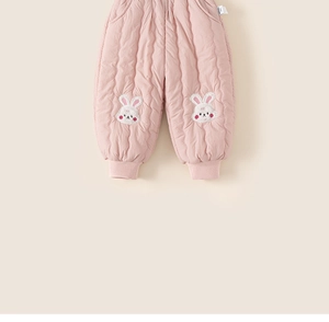 Détail de pantalon matelassé rose pour enfant avec patchs lapin et bords-côtes
