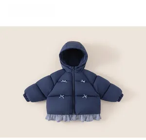 Detail of navy blue kids hooded coat with plaid patchwork hem and white cross stitching