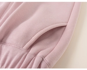 Detailed view of the side pocket and elastic waistband on pink fleece joggers for kids