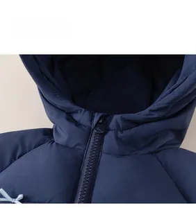 Detail view of girls navy hooded puffer jacket with zipper guard and bow accent