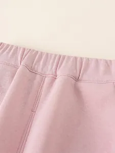 Pink fleece lined thermal joggers for girls featuring elastic waistband and soft cotton fabric