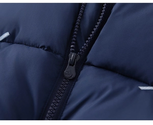Close-up of durable resin zipper and quilted fabric on kids' navy blue puffer jacket