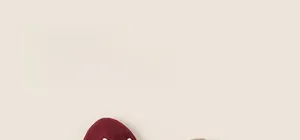 Detail view of thickened warm winter beanies for girls with flower design and pom-poms