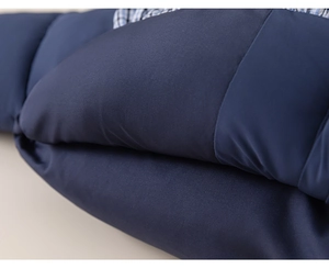 Close-up of navy quilted puffer jacket fabric with blue and white plaid lining detail