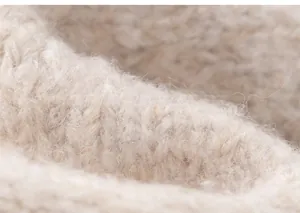 Macro shot of soft beige knitted fabric with plush texture and detailed weaving