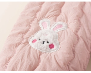 Vue détaillée du tissu matelassé rose avec broderie lapin en peluche 3D pour vêtement enfant