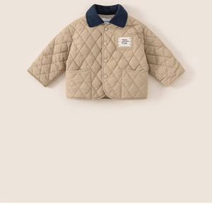 Close-up of diamond quilted texture and contrast corduroy collar on kids jacket