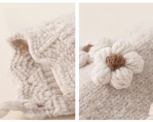 Detail of soft beige knit hat featuring handcrafted 3D crochet floral decorations