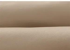Macro shot of khaki padded fabric texture showing fine weave on children's winter coat