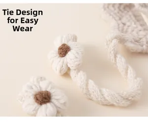 Detail of the crochet lace-up design with a cute heart flower on this warm winter hat