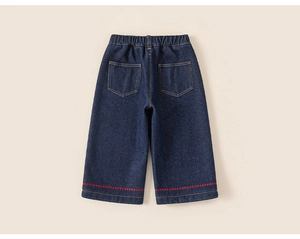Detail of kids denim trousers with elastic waist and red wavy embroidery on the leg cuff