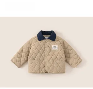 Close-up of quilted kids jacket featuring contrast navy collar and classic diamond pattern