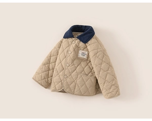 Detail of children quilted jacket with contrast corduroy collar and branded woven label