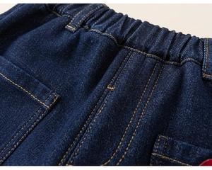 Close-up of kids thick winter denim jeans featuring an elastic waist and yellow stitching