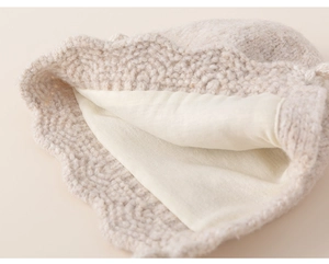 Detailed view of winter knitted hat showing warm inner lining and wavy crochet pattern
