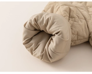 Detail of the diamond quilted pattern and sleeve cuff on this warm khaki winter jacket