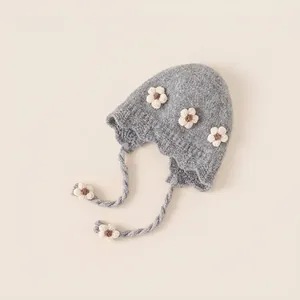 Grey knit winter hat for girls with white 3D flowers and windproof earflaps
