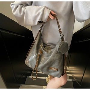 Close-up of retro hobo tote bag with adjustable brown strap and matching round coin purse