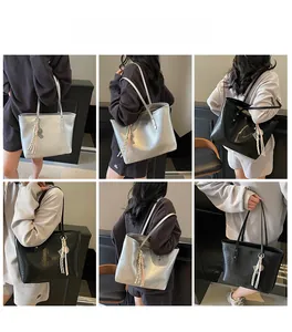 Detail showing high-capacity tote bags in metallic silver and black with tassel charm