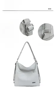 Close-up of adjustable silver metal buckle and nylon strap on light gray tote bag