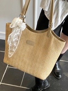 Large straw tote bag with leather straps and white lace scarf for summer fashion