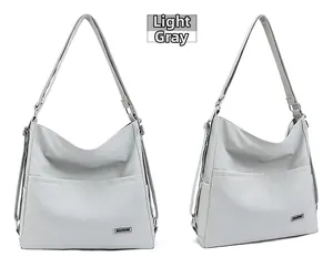 Detailed macro view of light grey tote bag showing fine leather texture and front pockets