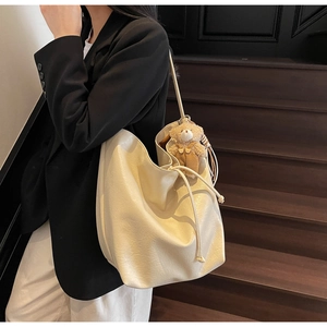 Chic cream white soft leather tote bag with drawstring closure and cute teddy bear charm