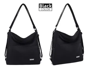 Detail view of large black tote bag featuring durable fabric and metallic strap hardware