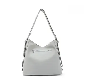 Detail view of the light grey tote bag featuring a practical back zipper pocket and metal rings