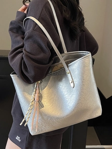 Metallic silver pleated tote bag for women with woven knot pendant and spacious interior