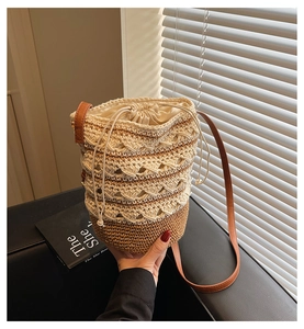Detailed macro view of woven boho bucket bag with hollow pattern and drawstring liner