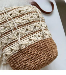 Detailed macro view showing the beige and brown hand-knitted texture and crochet patterns