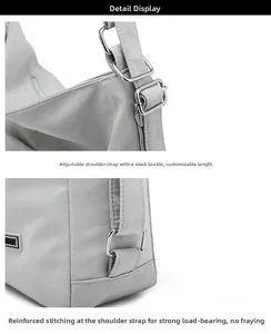 Detail display of silver metal adjustment buckle and reinforced stitching on tote bag