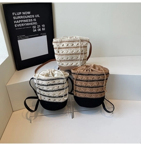 Detailed shot of bohemian crochet bucket bags with striped patterns and drawstring closure
