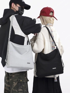 Minimalist large capacity canvas tote bag with wide strap for students and commuters
