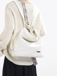 Versatile large capacity white tote bag with colorful striped straps and floral accents